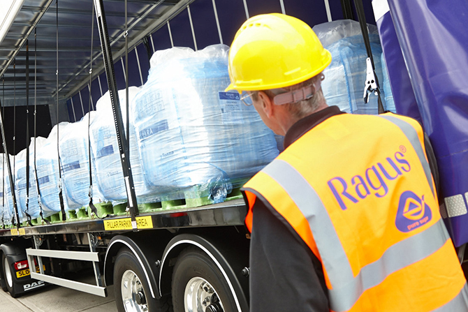 Close up shot of HGV driver securing bulk product on back of lorry