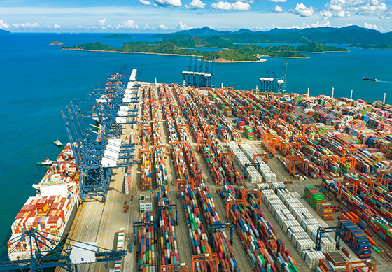 Birds eye view of Yantian port, showing thousands of shipping containers and bulk freight transportation methods