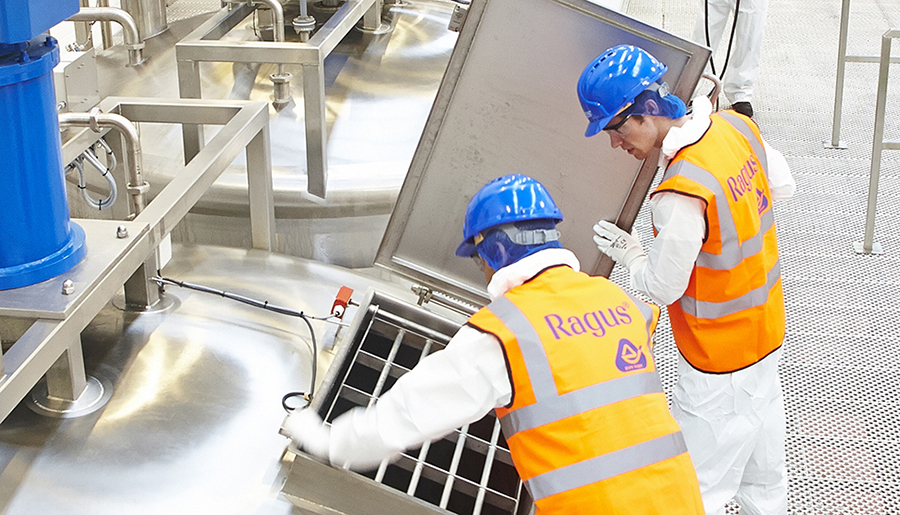 Ragus team members at a stainless steel production tank
