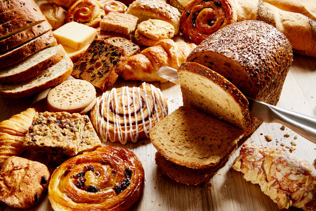 A collection of breads and baked goods including pastries and biscuits