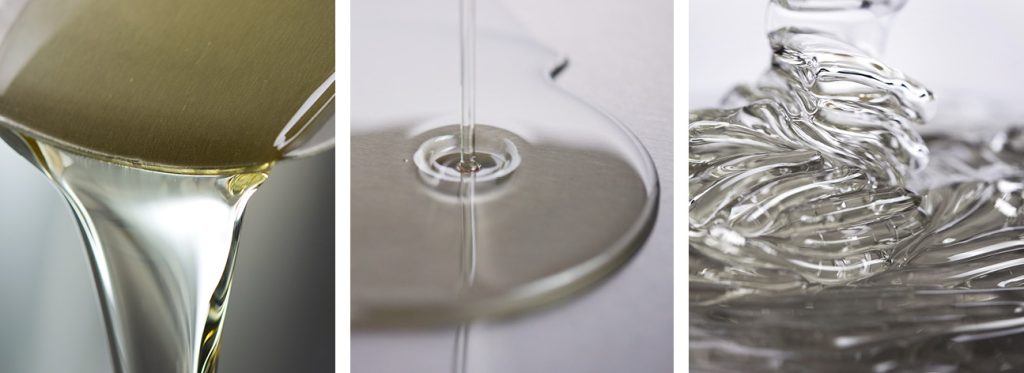 This is a picture showing three clear liquid sugar ingredients being poured, dispensed and viewed in close-up.